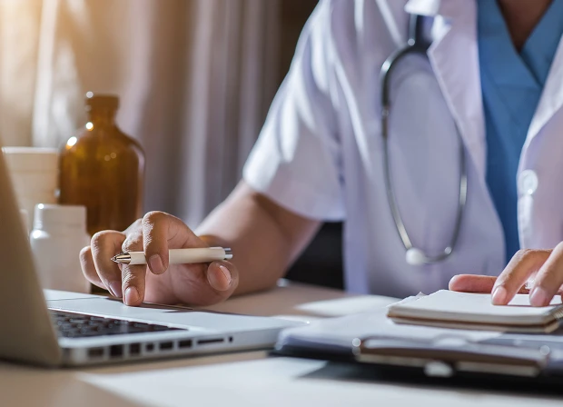 Healthcare industry card showing a medical professional writing notes